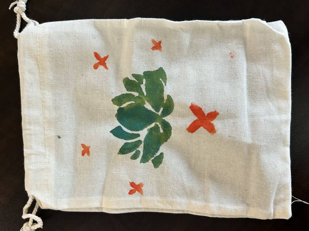 Hand-painted drawstring bag with a leaf design